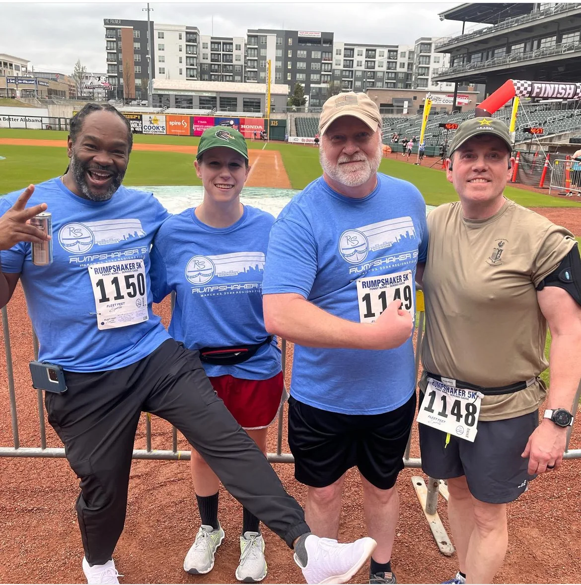 Four Rumpshaker participants posing together on the baseball field.